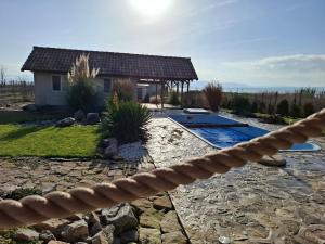 a backyard with a swimming pool and a house at ZanZebil in Zebil