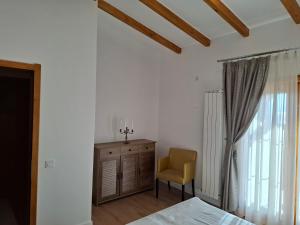 a bedroom with a bed and a chair and a window at ZanZebil in Zebil +29 photos