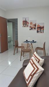 a living room with a table and chairs at Casa IBM - Crato in Crato