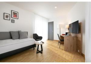 a living room with a couch and a desk at Brera Stuttgart in Stuttgart