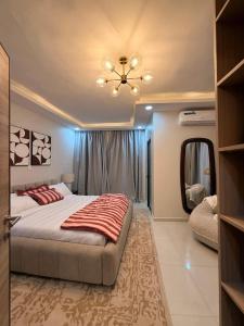 a bedroom with a large bed and a mirror at Cocon de paix à Ngor Virage in Dakar