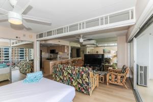 a living room with a couch and chairs and a kitchen at Ilikai Tower 1314 in Honolulu