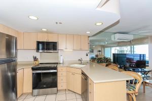 a kitchen with a sink and a stove top oven at Ilikai Tower 1314 in Honolulu