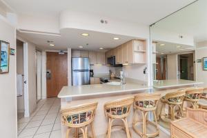 a kitchen with a counter and some bar stools at Ilikai Tower 1314 in Honolulu +6 photos