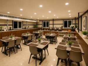 a restaurant with tables and chairs in a room at Urban Comforts - Near US Consulate Business Hotel in T Nagar in Chennai