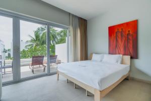 a bedroom with a large bed and a large window at NEW Serenity Tropical 2 Bed Condo On Beachfront in Ban Saiyuan (1) +63 photos
