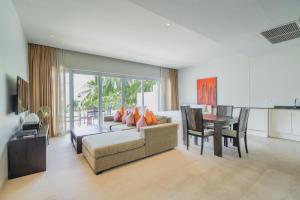 a living room with a couch and a table at NEW Serenity Tropical 2 Bed Condo On Beachfront in Ban Saiyuan (1)