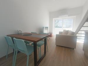 a dining room with a table and a couch at Tomarhousing - City Centre in Tomar