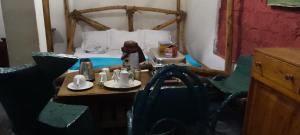a room with a table with two cups and a bed at Antique Lodge in Arusha +39 photos