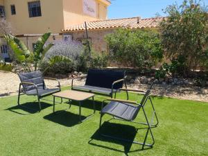 a group of chairs and a table on a lawn at Mas Solana in Huércal-Overa
