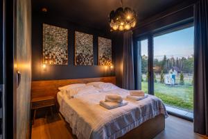 a bedroom with a bed with two pillows on it at Dom w czerni in Górniki