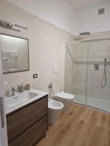a bathroom with a sink and a toilet and a shower at Malpensa Sleep & Go in Somma Lombardo +53 photos
