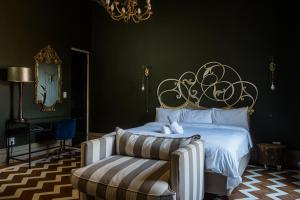 a bedroom with a bed and a chair and a mirror at Hagios House in Pretoria