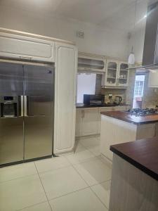 a kitchen with a stainless steel refrigerator and a counter at Ludinz Accomodation Self Catering in Avondale