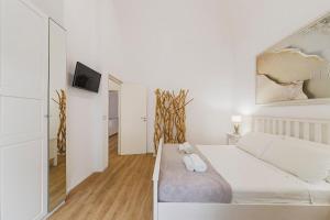 a white bedroom with a large white bed in a room at Best view Giovinazzo in Giovinazzo