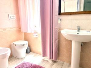 a bathroom with a toilet and a sink at Stefy's House in Scalea +68 photos