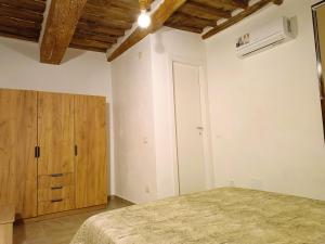 a bedroom with a bed and a wooden cabinet at Roveto Home in Siena