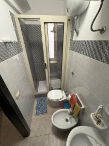 a bathroom with a sink and a toilet and a mirror at Blue Home in Lampedusa