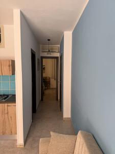 a hallway leading to a kitchen and a hallway to a house at Blue Home in Lampedusa
