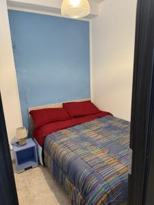 a bedroom with a bed with a red head board at Blue Home in Lampedusa