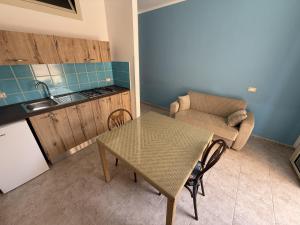 a small kitchen with a table and a chair in a room at Blue Home in Lampedusa