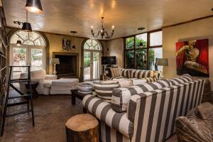 a large living room with couches and a chandelier at Hagios House in Pretoria