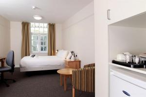 a hotel room with a bed and a table at 117 St Aldates Christ Church Accommodation in Oxford