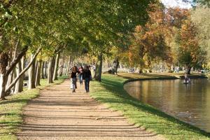 a group of people walking down a path next to a river at 117 St Aldates Christ Church Accommodation in Oxford