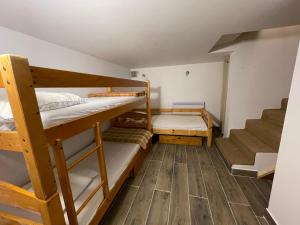 a room with two bunk beds and a staircase at Chalet Maria in Samoëns