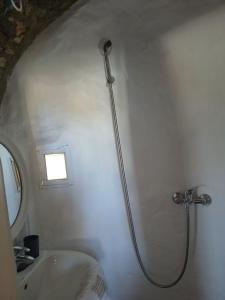 a shower in a bathroom with a sink at The Windmill in Symi