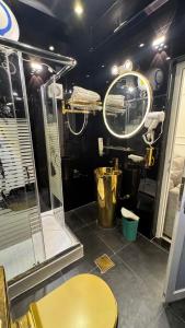 a bathroom with a shower and a sink and a mirror at كورنيش عجمان in Ajman 