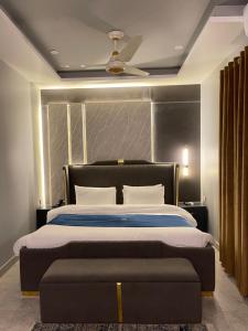 a bedroom with a large bed and a ceiling at Grand Blu Hotel in Hyderabad +56 photos