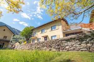 a stone wall in front of a house at Scenic Alps View Getaway in Aquila