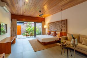 a bedroom with a bed and a couch at Cascara Resort Weligama - A Tropical Sanctuary in Weligama +72 photos