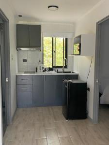 a kitchen with blue cabinets and a sink at Refugio Callihue in El Ajial