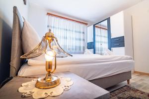 a bedroom with a bed and a lamp on a table at Scenic Alps View Getaway in Aquila