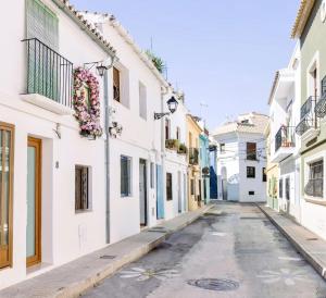an empty street in positano with white buildings at Casa Sol in Denia