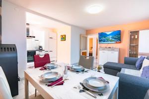 a living room with a table with plates on it at Scenic Alps View Getaway in Aquila +27 photos