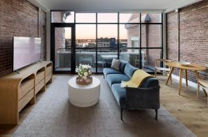 a living room with a blue couch and a table at The Evalina Hotel in Portland