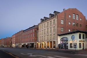 an empty city street with brick buildings on a street at The Evalina Hotel in Portland