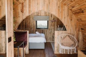 a bedroom with a bed and a chair in a room at Doxford Farm Camping in Alnwick
