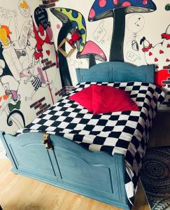 a bedroom with a bed with a checkered bedspread at La Berlingote in Cherbourg en Cotentin