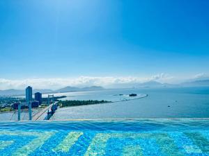 a swimming pool with a view of the water at Golden Apartment in Da Nang Bay in Danang