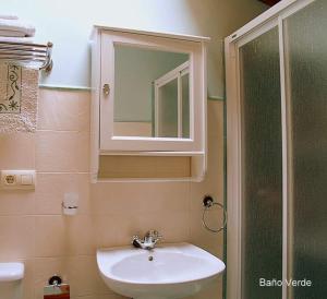 a bathroom with a sink and a mirror and a shower at Casa de Pamirandi in Asiego +10 photos