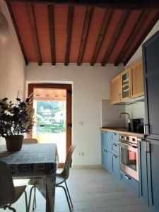 a kitchen with a table and a table and a dining room at Casa Peppo in Marciana