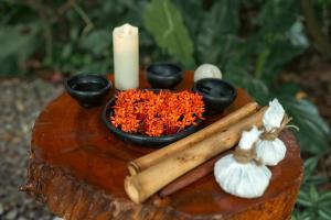 a table with a candle and a bowl of rice and chopsticks at Hotel MulataRetreat in La Mesa +34 photos