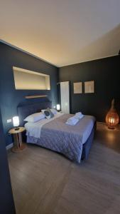 a bedroom with a large bed and two lamps at Cristina Home in Taranto