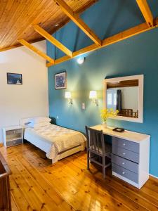 a bedroom with a bed and a desk and a mirror at Starvillas Apartments and Studios in Agia Effimia