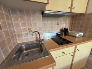 a kitchen with a sink and a counter at Vythos Rooms in Paralio Astros +80 photos