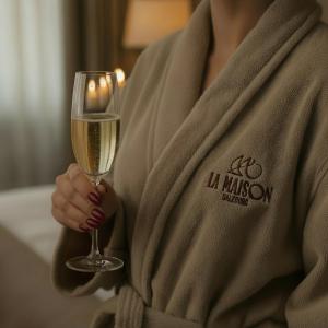 a woman is holding a glass of wine at La Maison in Salzburg
